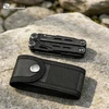 Herramienta multiusos negra HX Outdoors con funda de nailon sobre una roca al aire libre